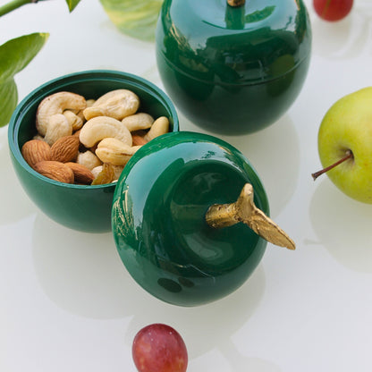 Green apple-shaped metal jars with golden stem for décor and dry storage