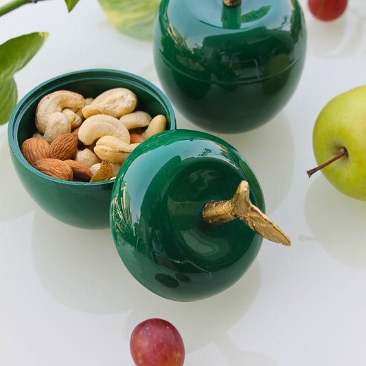 Green apple-shaped metal jars with golden stem for décor and dry storage